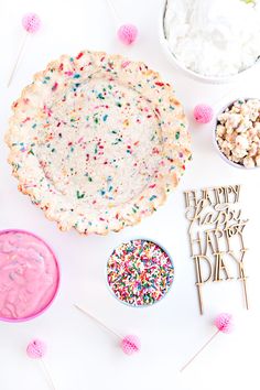 a birthday cake with sprinkles, marshmallows and other treats