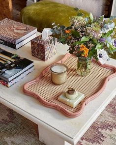 a coffee table with flowers and books on it