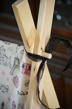 a wooden chair with a black ribbon tied to it