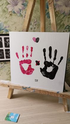 an easel with two hand prints on it