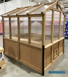 a large wooden greenhouse in a warehouse