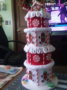 a christmas cake made to look like it is stacked on top of each other with candy canes and candies