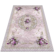 a pink rug with purple flowers on the bottom and gold trimmings around it