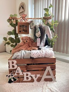 a baby's bed with clothes and toys on it