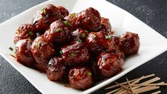 a white plate topped with meatballs and chopsticks