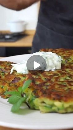 a person standing over a plate with food on it