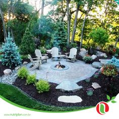 a fire pit surrounded by chairs and trees