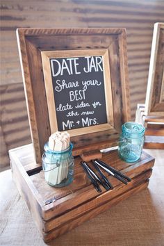 a wooden box with two jars and some chopsticks in it next to a chalkboard sign that says date jar share your best