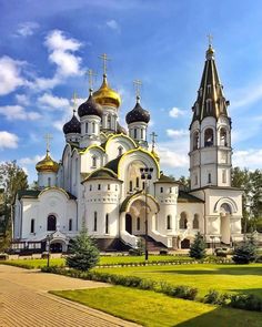 a large white and gold church with two towers