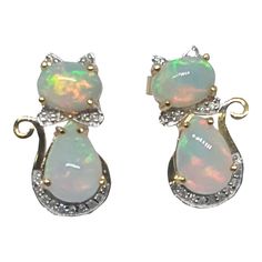 Ethiopian Opal Diamond 14k Solid Gold Kitty Cat Earring Cat Bow Stud Earrings.  Gold Weight: 2.80 Grams Approx. Earrings Size: 20x13mm Approx.  Oval Opal Size: 6x8 mm Approx. Pear Opal Size: 7x10 mm Approx. Diamond Count: 32  Diamond Size: 1.10 / 1.00 mm Approx. Diamond Color: H. Diamond Clarity: VVS2. Cat Earring, Pink Stud Earrings, Ruby Earrings Studs, Blue Stud Earrings, Rose Gold Earrings Studs, Pink Studs, Stud Earrings Gold, Cat Bow, Rose Gold Studs