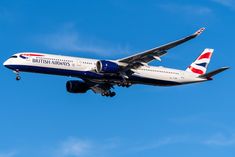 a british airways plane flying in the air with its landing gear down and it's landing gear down