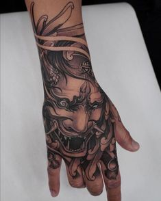 a person's hand with tattoos on it and a tattoo design on the wrist