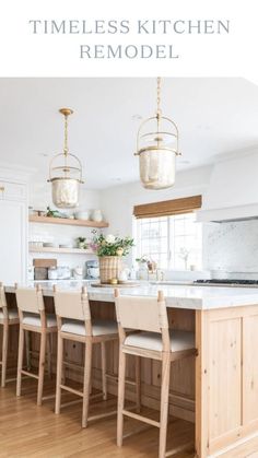 a large kitchen with wooden floors and an island in the middle, surrounded by hanging lights