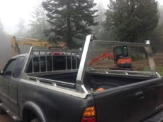 the back end of a pickup truck with an excavator in the back