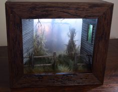 a wooden frame with an image of a house in the fog