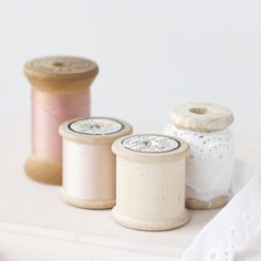 three spools of thread sitting next to each other