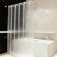 a white toilet sitting next to a shower in a bathroom