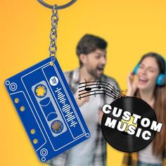 two people with headphones and a keychain that says custom music on it