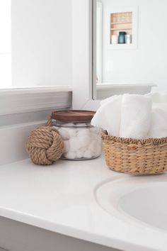 a bathroom with a basket and soap on the counter