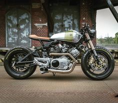 a motorcycle parked in front of a brick building