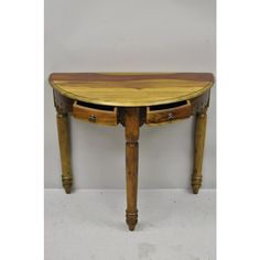 a wooden table with two drawers on one side and an oval shaped drawer on the other