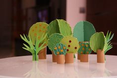 some paper trees are sitting on a table