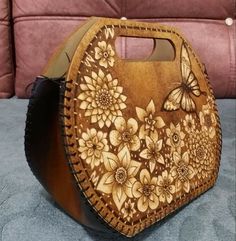 a wooden purse with flowers and butterflies on it