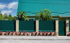 a building with green shutters on the front and side