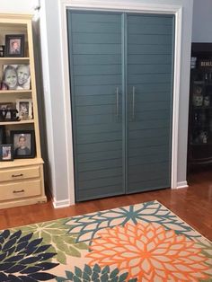 a bedroom with a large blue closet next to a book shelf