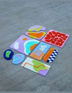 several colorful rugs laid out on the ground with different shapes and sizes to make them look like they are made from felt