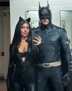 two people dressed up as batman and catwoman