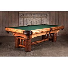 a pool table made from an old wooden frame with green cloth on the top and legs