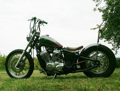 a motorcycle parked on top of a lush green field