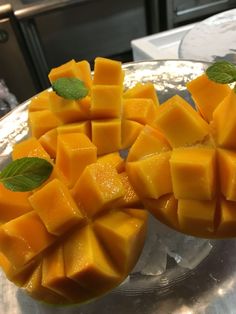 several pieces of mango sitting on top of a glass plate