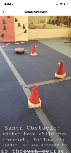 there are three cones on the floor with santa's hats