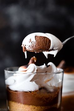 a spoonful of chocolate pudding with whipped cream