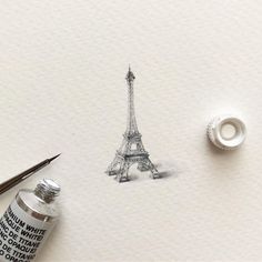 a drawing of the eiffel tower is shown next to a marker and pen