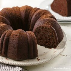 a bundt cake sitting on top of a white plate next to another bundt cake