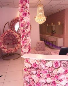 a flower covered counter in a salon with chandelier