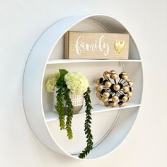 a white shelf with some flowers on it