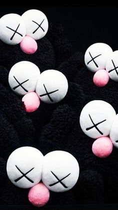 several white and pink marshmallows with crosses painted on them in the shape of hearts