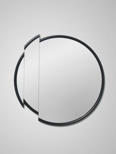 a round mirror with two black lines on it