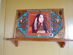 a wooden shelf with a painting on it