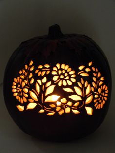 a carved pumpkin with flowers on it