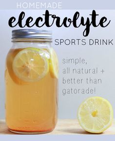 a mason jar filled with lemonade next to a sliced lemon and the words, homemade electrolyte sports drink