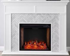 an electric fireplace with white marble tile and red flames in the center, surrounded by herringbone tiles