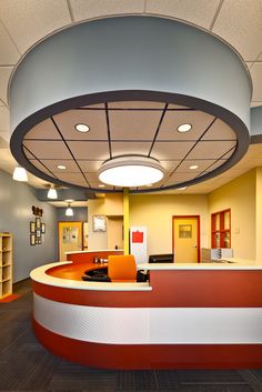 the interior of an office with a curved counter