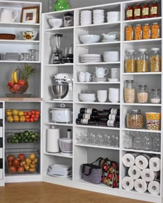 an organized pantry with white shelving and lots of food