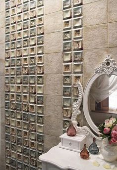 a bathroom with a vanity, mirror and vases on the counter in front of it