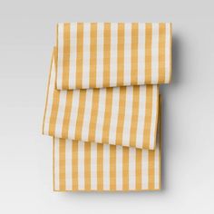 two yellow and white striped sheets folded on top of each other